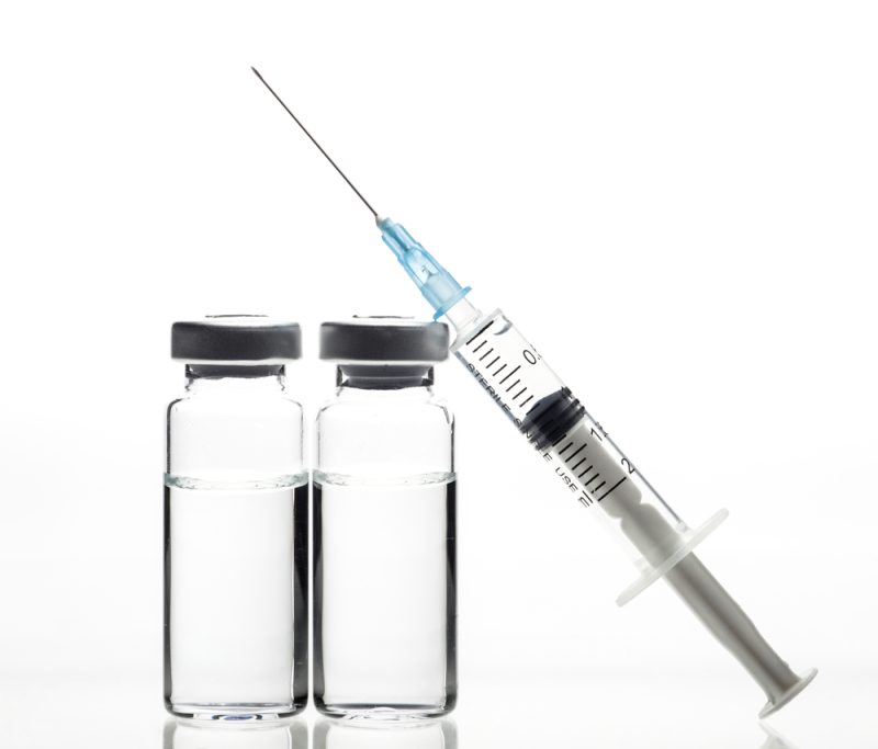 glass-medicine-vials-and-syringe-on-white-background