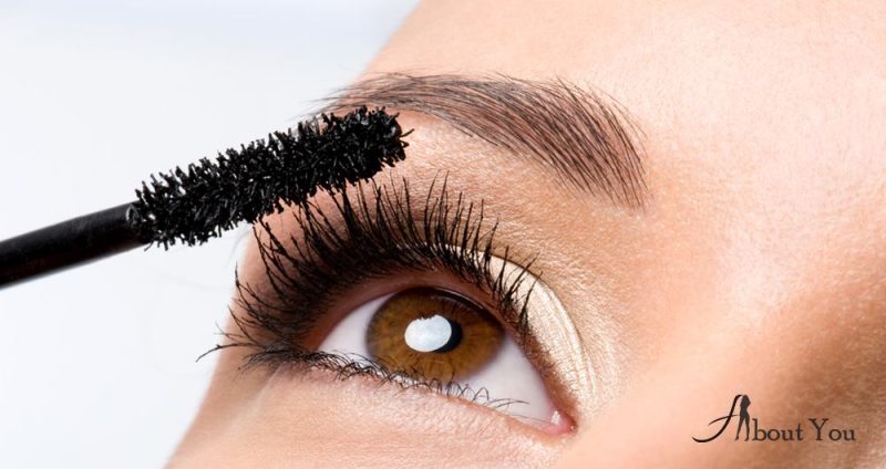 woman-applying-mascara-on-her-eyelashes-macro-shot